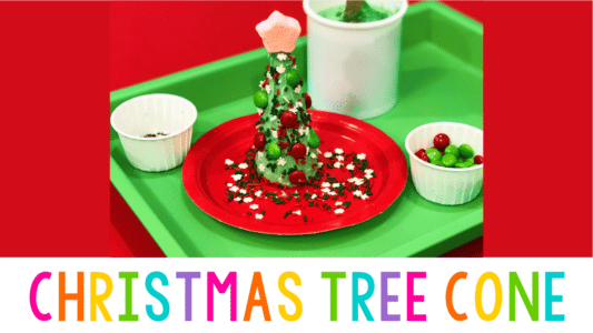 a pointed sugar cone standing on a plate covered in green frosting and sprinkles