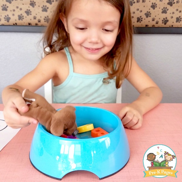 girl playing the alphabet puppy chow game for kids
