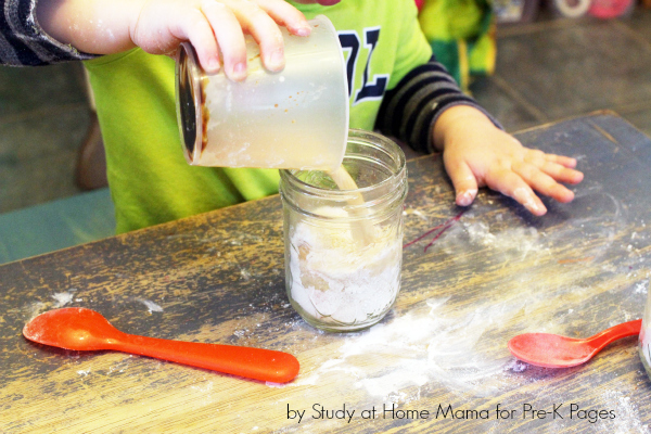 wet ingredients being added to mason jar of dry ingredients for gingerbread in a jar