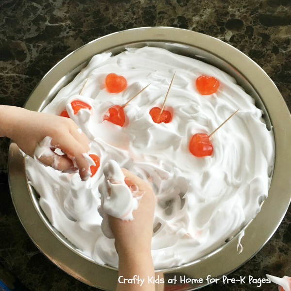 children's hands paying in shaving foam