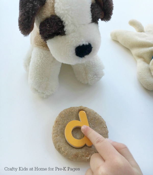 letter d being pushed into playdough