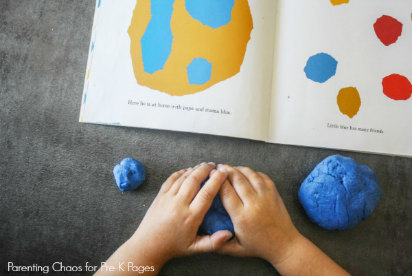 child playing with blue playdough