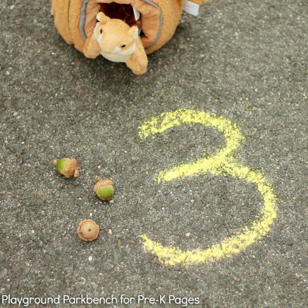 number 3 in chalk with 3 acorns