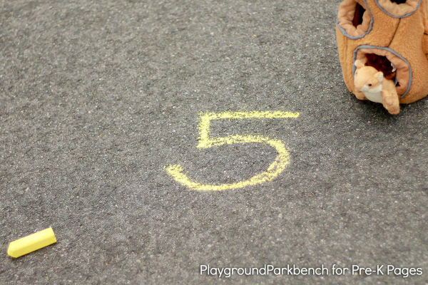 piece of chalk and the number 5 written in chalk on pavement