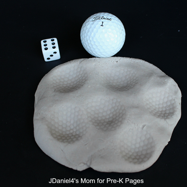 play dough, golf ball, and dice for moon math activity