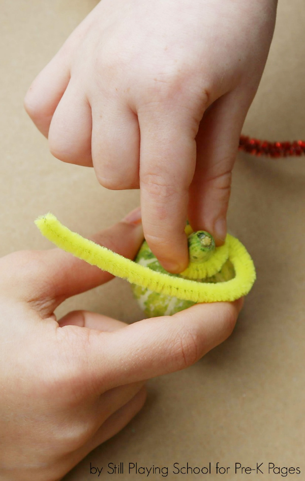 child's hands playing with toys in tinker tray