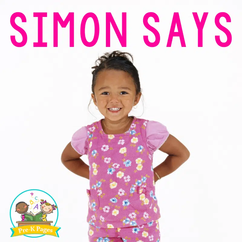 a little girl wearing a pink jumper with hands on her hips