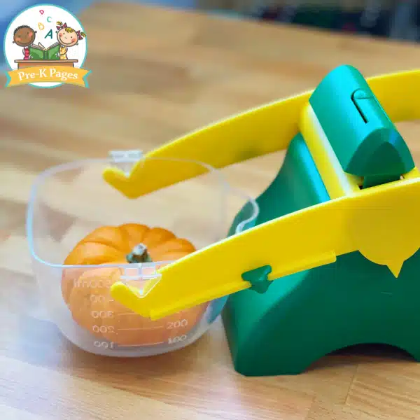 mini pumpkin in a balance scale