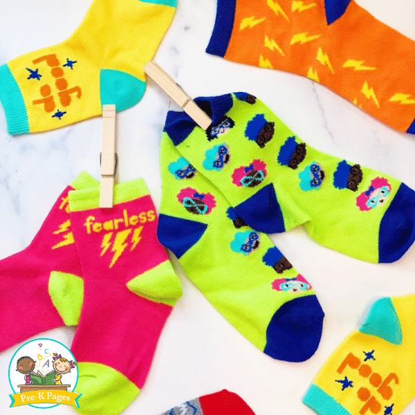 colorful socks in pairs clipped together with clothespins