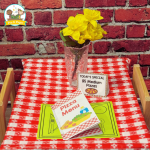 checkered tablecloth with yellow flowers in vase