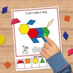 a childs hand putting a pattern block on a mat featuring a dog